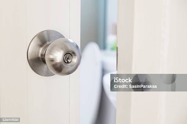 Closeup Door Stainless Door Knob With Door Open Slightly Stock Photo - Download Image Now