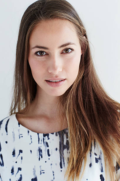 istock Beautiful young woman looking at camera 526142236