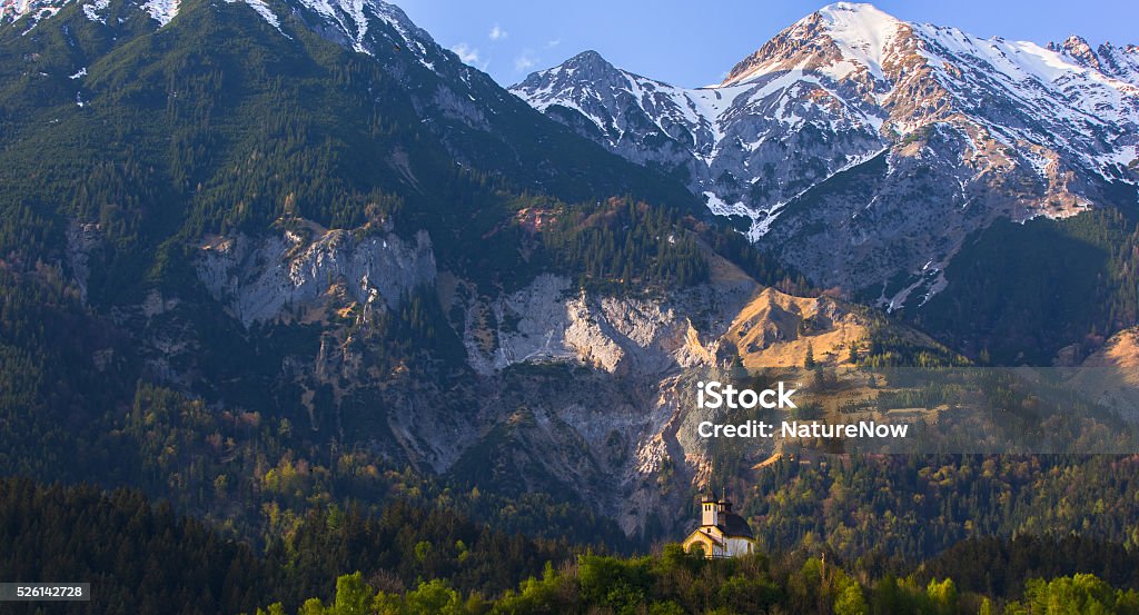 Chapel, Austrian Alps Chapel in the Austrian Alps in spring. While the woods turn green again, the snowcaps on the peaks of the Austrian Alps slowly melt. Austria Stock Photo