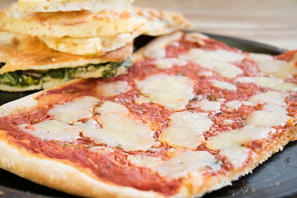 istock square pieces of homemade pizza in a baking tray 526144292