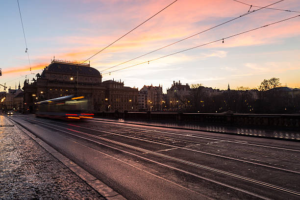 Prague, Czech Republic - December 6, 2015: Colourful Sunrise in Prague. The outside of buildings and traffic can be seen.