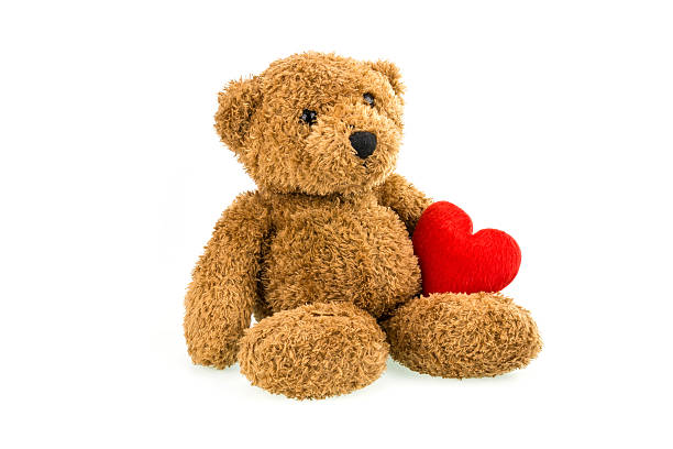 istock Teddy bear with red heart isolated on white 526146304