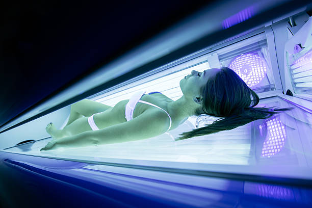 istock Beautiful brunette sunbathing in solarium 526149412