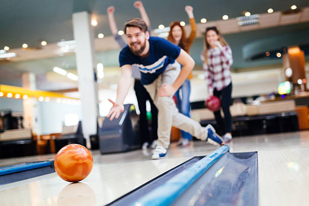 Friends having fun while bowling Friends having fun while bowling and speding time together ten pin bowling stock pictures, royalty-free photos & images