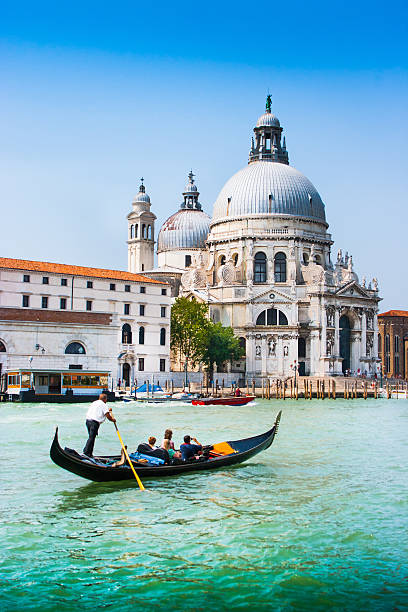 Gondola on Canal Grande, Venice, Italy Traditional Gondola on Canal Grande with Basilica di Santa Maria della Salute in the background, Venice, Italy. venice italy stock pictures, royalty-free photos & images