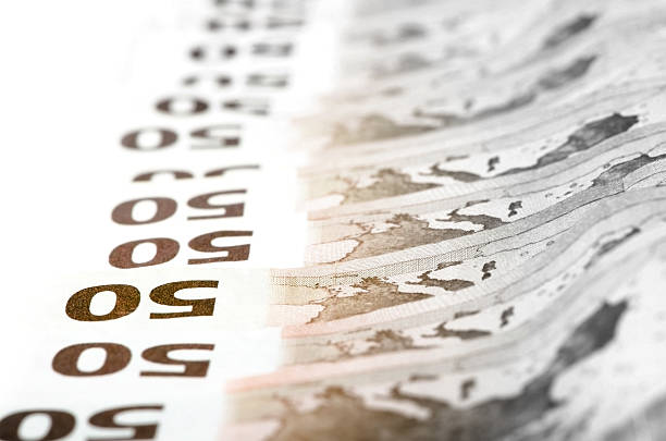 istock Fifty euro bills stacked in a row 526151828