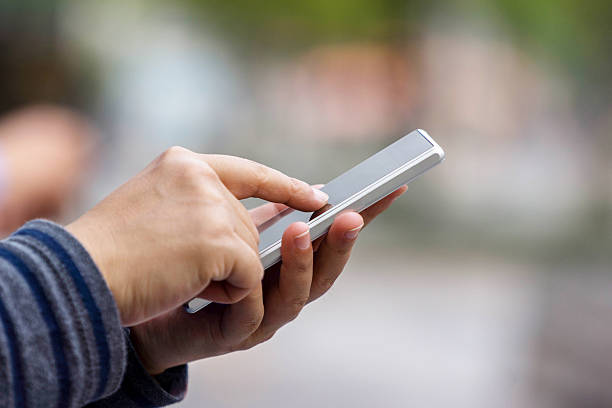 istock finger touching screen of smart phone 526152746