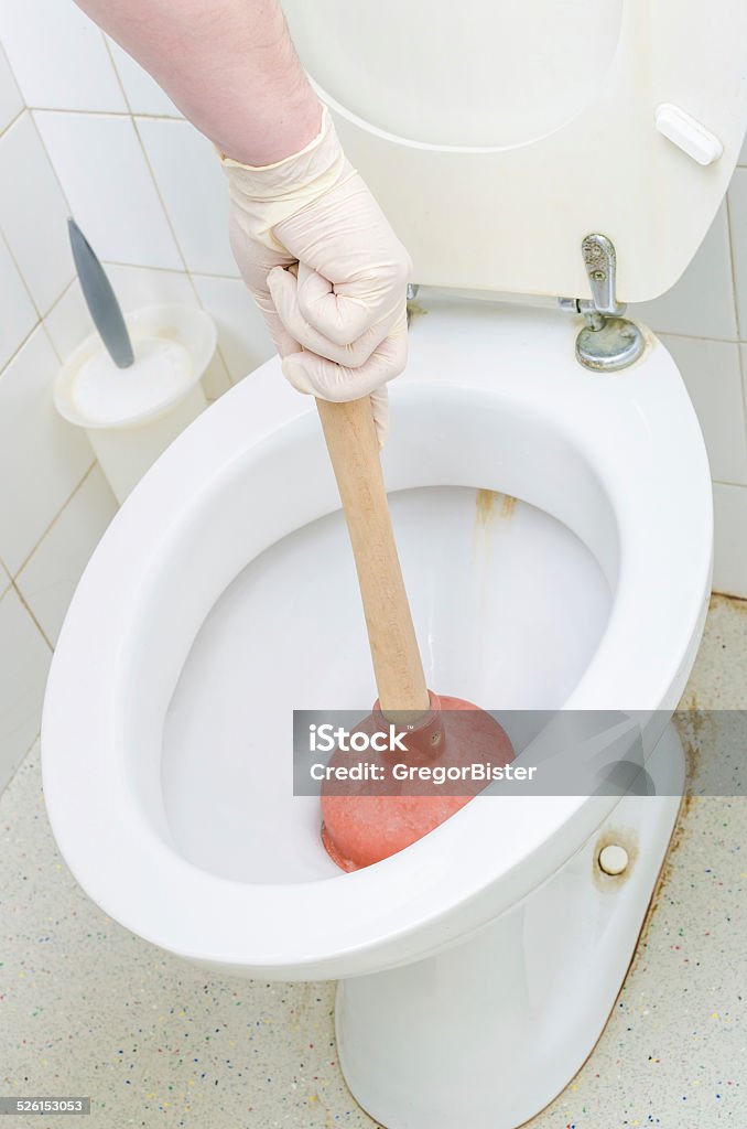 Plunger Plunger working on Toilet Clog Clogged Stock Photo