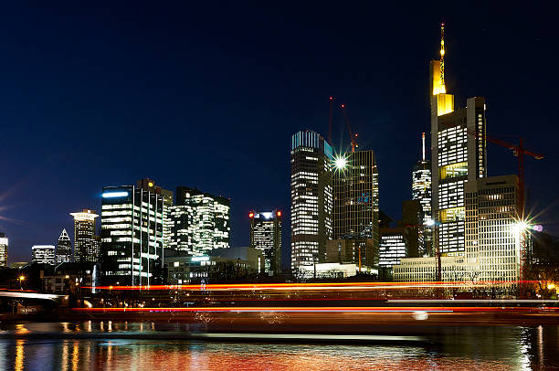 Frankfurt am Main at night. Red light trails of a passing ship.
