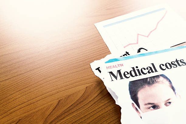istock Newspaper articles on medical costs with a rising graph 526153381