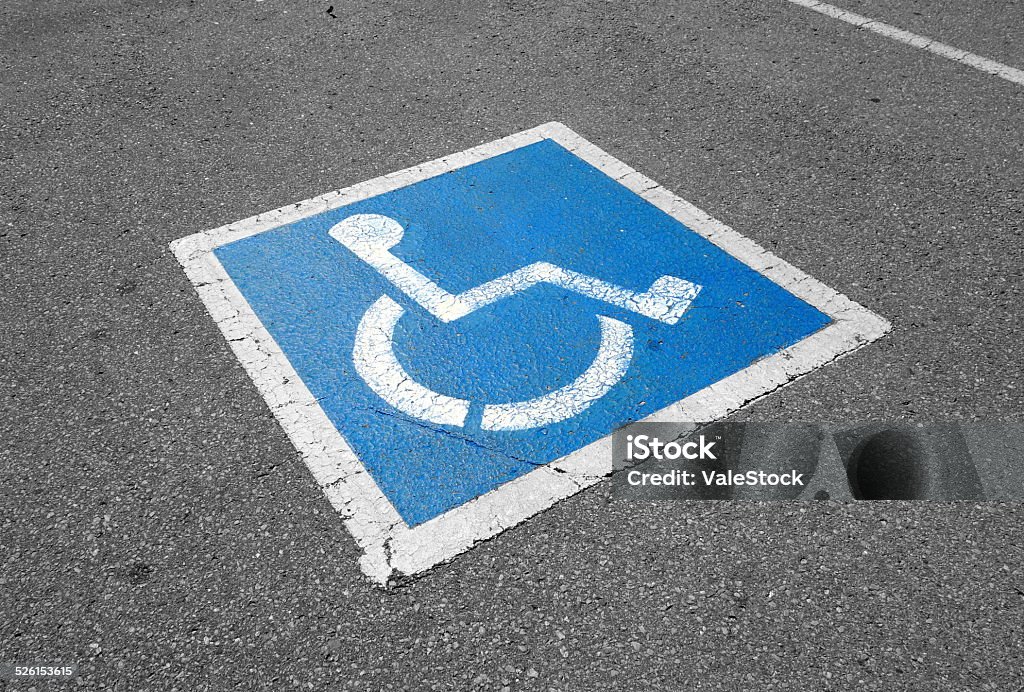 Disabled Sign International handicapped symbol painted in bright blue on a shopping center parking space Accessibility Sign Stock Photo