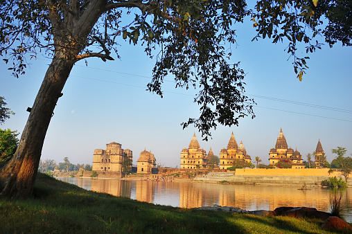 beautiful scene on the banks of Betwa ( or Chhatris) River, at Orchha, Madhya Pradesh in India. The old buildings far away are group of cenotaphs of Bundela Kings and their clan.