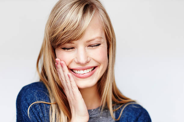 istock Laughing young blond woman with eyes closed 526153782