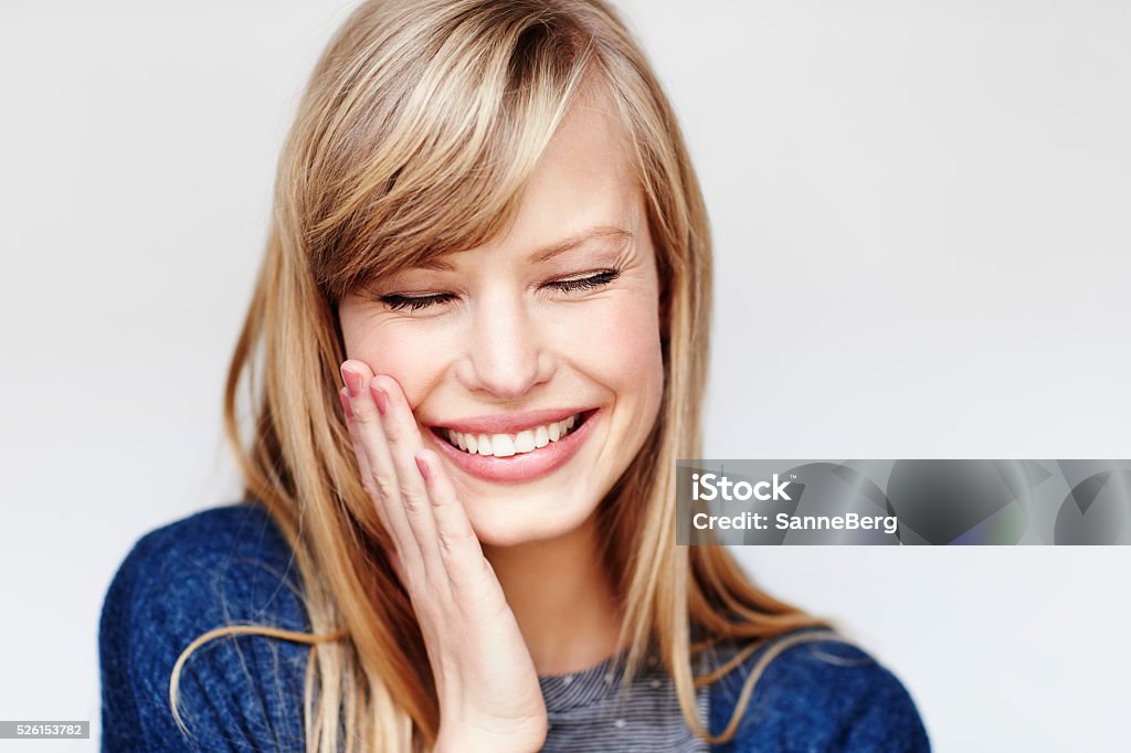 Laughing young blond woman with eyes closed Blond Hair Stock Photo