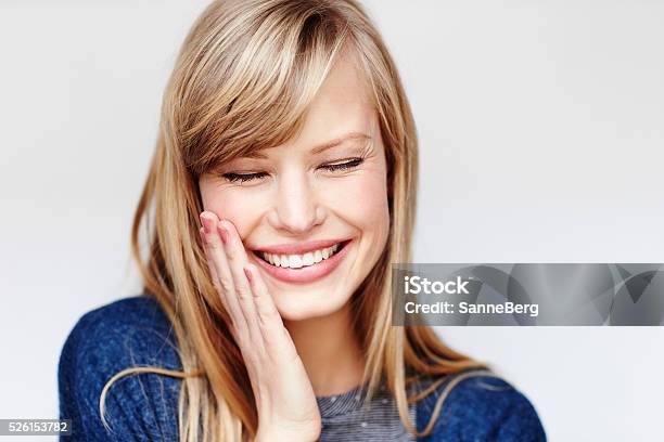 Laughing Young Blond Woman With Eyes Closed Stock Photo - Download Image Now - Blond Hair, Portrait, White Background