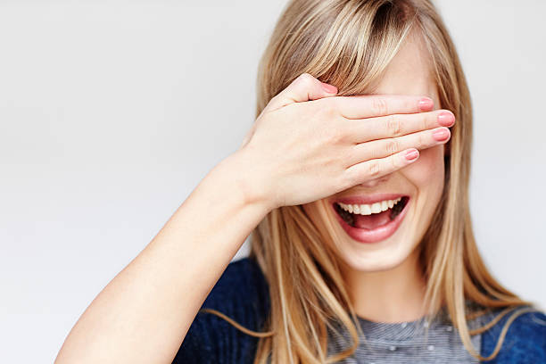 istock Young blond woman with hand over eyes, studio 526153834