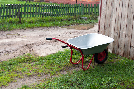 Wheelbarrow gardening tool on green grass