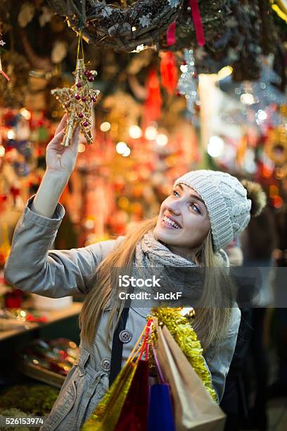 Girl Choosing Christmas Gifts Outdoor Stock Photo - Download Image Now - Adult, Bag, Celebration