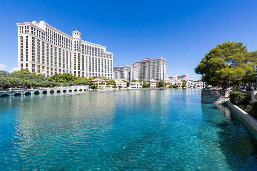 October 17, 2018 - Las Vegas, United States: Skyscraper towers of Bellagio, Caesars palace and the Cosmopolitan hotels reflected in the man made lake Bellagio. The luxury resort hotels are located on the Las Vegas strip.