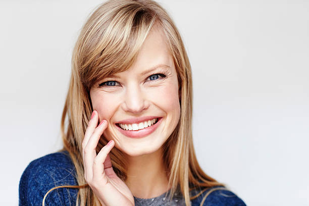 istock Happy blond young woman smiling, studio 526154332