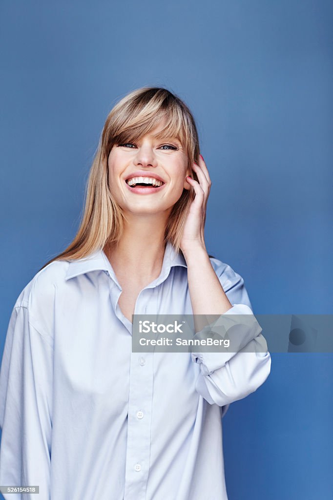 Happy blond beauty in blue shirt, portrait One Woman Only Stock Photo