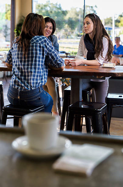 Group of friend eating outdoors, focus on foregrounds