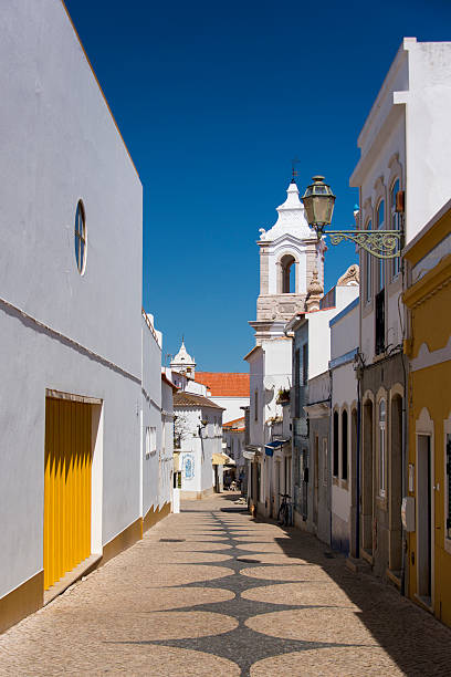 Small street in the historic center of Lagos with the church of St. Anthony in the Algarve region of Portugal.