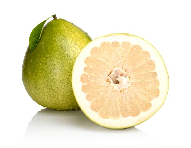istock Two pomelos,half with drops water,leaf isolated on white 526156333