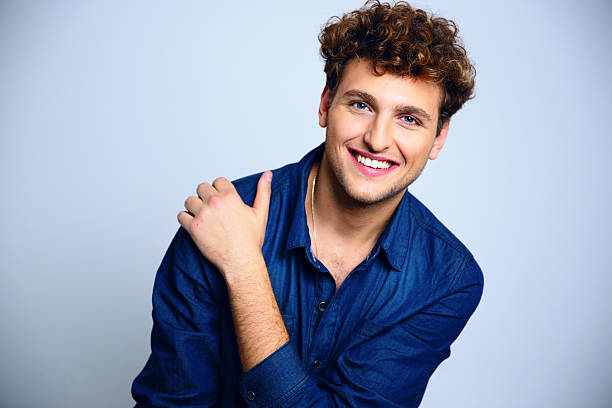 istock happy young man with curly hair 526156625