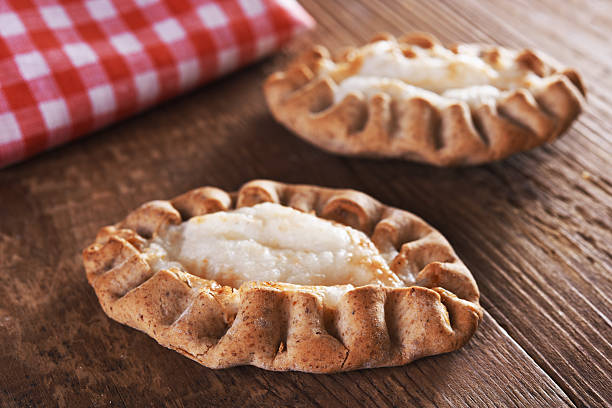 karelian pasty traditional karelian pie over wooden background finnish culture stock pictures, royalty-free photos & images