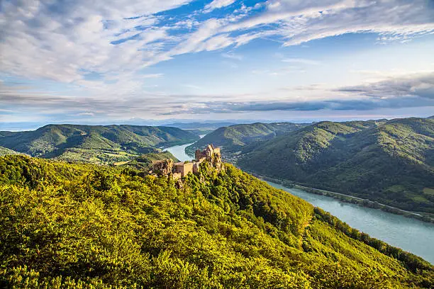 Beautiful landscape with Aggstein castle ruin and Danube river at sunset in Wachau, Austria.