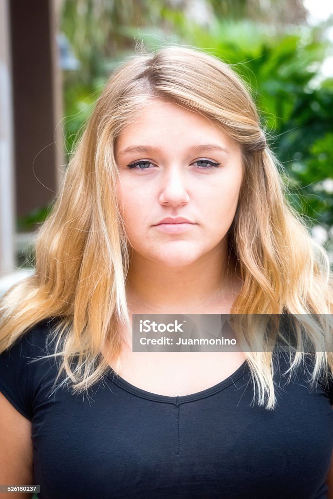 Serious teenage girl Serious teenage girl looking at the camera Overweight Stock Photo