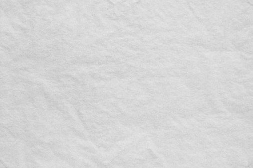 the white textured background from a thin crumpled tissue paper or a tracing-paper