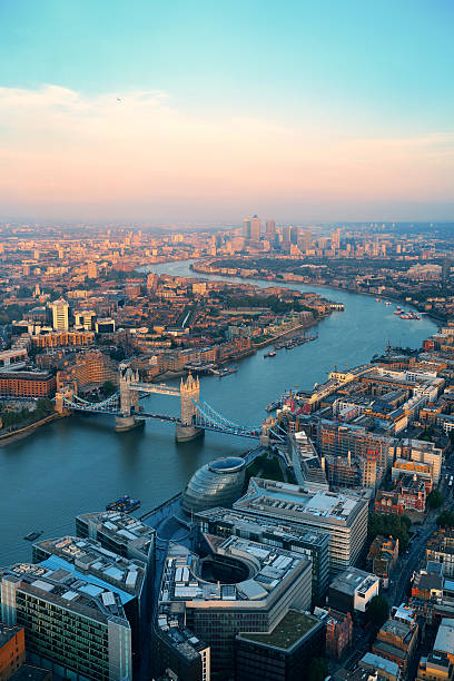 London aerial London rooftop view panorama at sunset with urban architectures and Thames River. thames river stock pictures, royalty-free photos & images