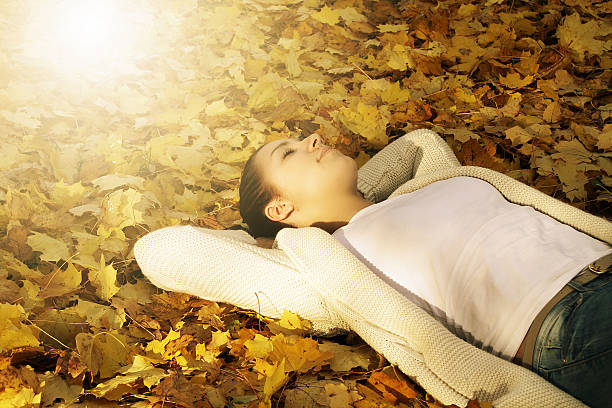 istock Young woman sleeping on the leaves 526197935