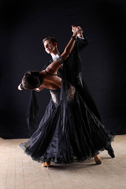 istock dancers in ballroom isolated on black background 526198719