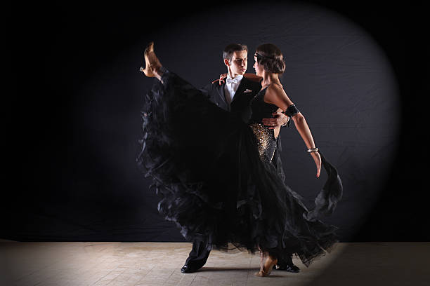 istock dancers in ballroom against black background 526198731