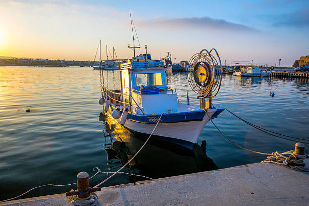 Fishing Boat, Paphos Harbour, Cyprus. This photo was taken on 23rd May 2014 at 06:15 hours, sunrise I was looking for a secluded boat with the sunrise just hitting on the side for a more at Sunrise composition. The colours are strong with a peaceful and serene feel