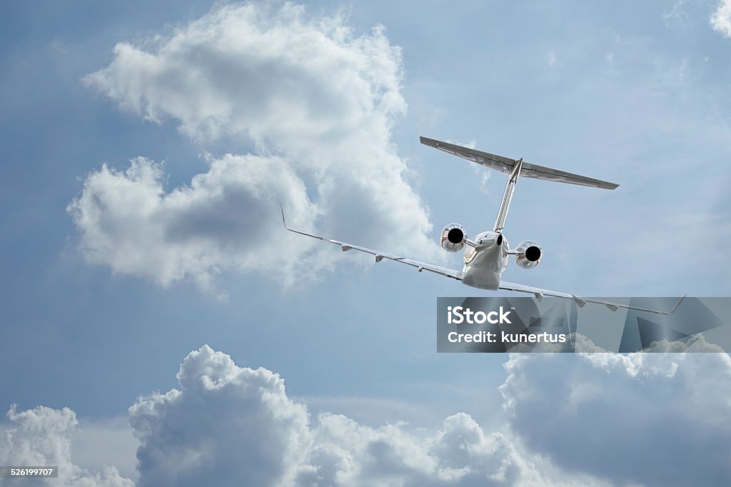 Private Jet inflight Following a private jet flying through the clouds Air Vehicle Stock Photo