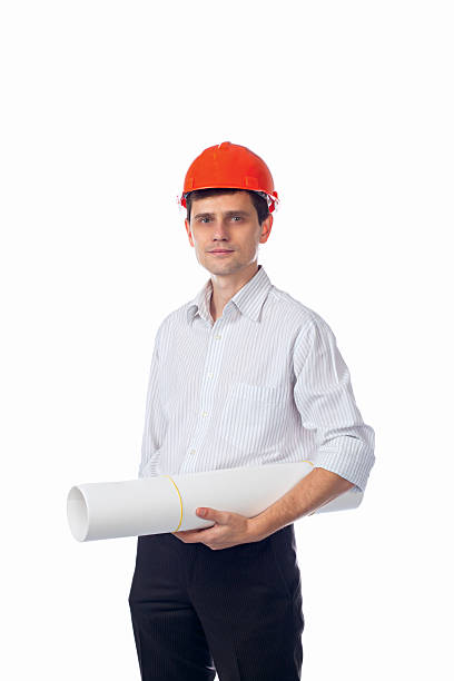 istock man in shirt, orange construction helmet with a roll of 526211301