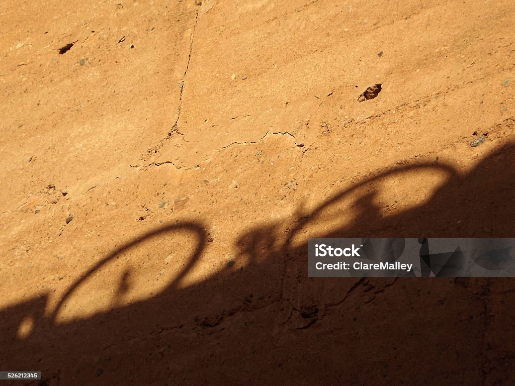 Bicycle Shadow on a Wall of the El Badi Palace One of the countless bicycles in Marrakech throws its shadow on a golden wall of the El Badi Palace. Ancient Stock Photo