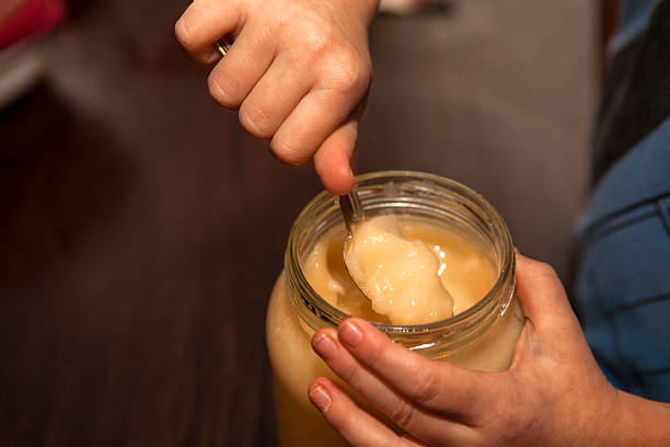 istock Jar of honey and hands 526223117
