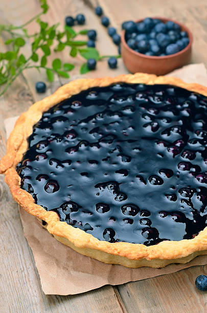 istock Blueberry pie and fresh berries on rustic wooden table 526225833