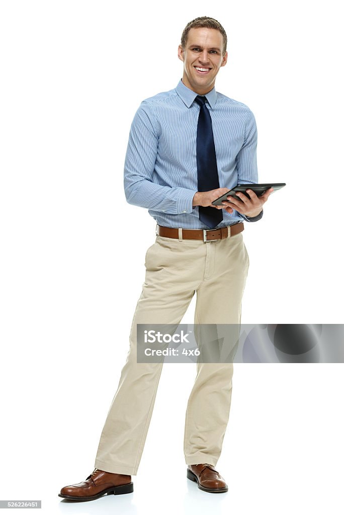 Smiling businessman working on tablet Smiling businessman working on tablethttp://www.twodozendesign.info/i/1.png Digital Tablet Stock Photo