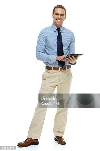 Smiling Businessman Working On Tablet Stock Photo - Download Image Now - Digital Tablet, Businessman, Full Length