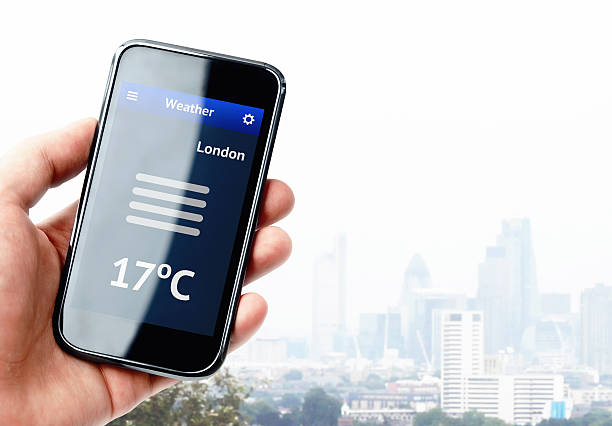 istock Hand holding smartphone with weather in London 526227421