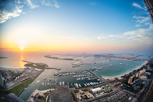 The palm Jumeirah in Dubai with skyline at sunset