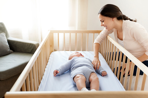 Mother watching baby in his room