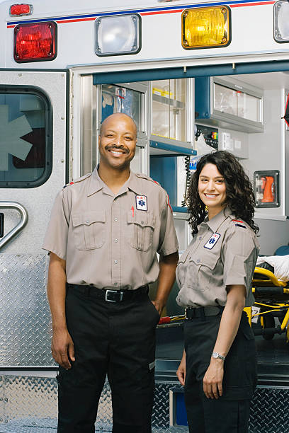 istock Two paramedics outside ambulance, portrait 526235481
