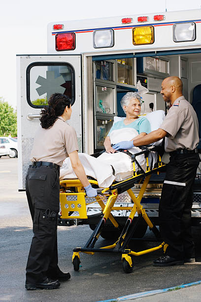 istock Two paramedics putting patient into ambulance 526235483